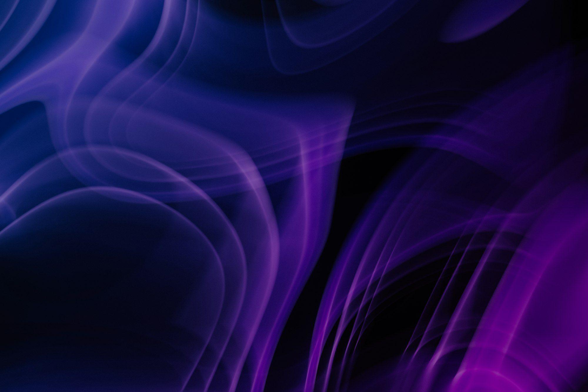 Flowing violet and deep-blue light trails on a black background.